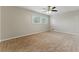 Bright bedroom features neutral walls, plush carpeting, a ceiling fan, and natural light from the windows at 135 S Falcon Blf, Alpharetta, GA 30022