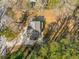 An aerial view showcasing the home with lush tree coverage, deck, and driveway at 1596 Willowbrook Sw Dr, Atlanta, GA 30311