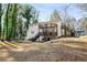 The back of the home features decks and a stairway leading to a spacious, private backyard at 1596 Willowbrook Sw Dr, Atlanta, GA 30311