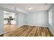 Open basement area with new light wood flooring with full kitchen on the side at 1596 Willowbrook Sw Dr, Atlanta, GA 30311