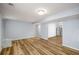 Open basement area with new light wood flooring, and full kitchen on the side at 1596 Willowbrook Sw Dr, Atlanta, GA 30311