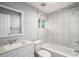 Modern bathroom with tub, shower and marble tiled walls at 1596 Willowbrook Sw Dr, Atlanta, GA 30311