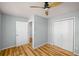 Spacious bedroom with wood floors, a ceiling fan, and ample closet space at 1596 Willowbrook Sw Dr, Atlanta, GA 30311