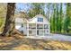 Charming white two-story home featuring double balconies and stairs to backyard at 1596 Willowbrook Sw Dr, Atlanta, GA 30311