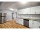 Bright kitchen featuring a stainless steel fridge, granite countertops, and white cabinetry at 1596 Willowbrook Sw Dr, Atlanta, GA 30311