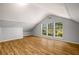 Spacious living room featuring wood floors, vaulted ceilings, and large windows at 1596 Willowbrook Sw Dr, Atlanta, GA 30311