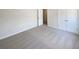 This bedroom features neutral carpeting and double door closet at 501 Fable Ln, Canton, GA 30114