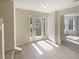 Light-filled foyer with tiled floor, stylish front door, and adjacent living spaces at 501 Fable Ln, Canton, GA 30114
