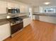Well-equipped kitchen with stainless steel appliances and durable hard surface countertops at 501 Fable Ln, Canton, GA 30114