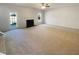 Spacious living room with cozy fireplace, neutral carpet, and door to backyard at 501 Fable Ln, Canton, GA 30114