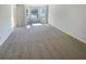 Spacious living room with large windows, neutral paint and carpet throughout at 501 Fable Ln, Canton, GA 30114