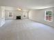 Spacious living room featuring neutral carpeting, fireplace and three windows at 501 Fable Ln, Canton, GA 30114