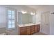 Bathroom with a large mirror over a double sink vanity, and a window with white shutters at 625 Aunt Lucy Ln # 45, Smyrna, GA 30082