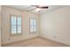Bedroom with neutral carpet, ceiling fan and two windows with white shutters at 625 Aunt Lucy Ln # 45, Smyrna, GA 30082