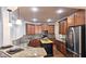 Spacious kitchen with wood cabinets, granite countertops, stainless steel appliances, and kitchen island at 625 Aunt Lucy Ln # 45, Smyrna, GA 30082