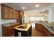 Bright kitchen with granite countertops, stainless steel appliances, wood cabinets, hardwood floors, and kitchen island at 625 Aunt Lucy Ln # 45, Smyrna, GA 30082
