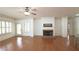 Spacious living room with hardwood floors, fireplace, ceiling fan, and bright windows with plantation shutters at 625 Aunt Lucy Ln # 45, Smyrna, GA 30082