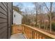 Wood-railed balcony offering views of wooded backyard and neighboring home at 1005 Sims Nw Ave, Atlanta, GA 30318