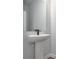 Bathroom features a pedestal sink with modern faucet and a frameless mirror at 1005 Sims Nw Ave, Atlanta, GA 30318