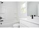 Bathroom featuring a shower/tub combo with white tile surround and modern vanity at 1005 Sims Nw Ave, Atlanta, GA 30318