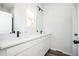 Bathroom showcasing a dual sink vanity with white countertop and black fixtures at 1005 Sims Nw Ave, Atlanta, GA 30318