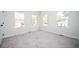 Bright bedroom featuring carpeted floor, white walls and three windows offering natural light at 1005 Sims Nw Ave, Atlanta, GA 30318