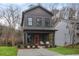 Charming two-story home with a modern facade, orange door, and a cozy front porch at 1005 Sims Nw Ave, Atlanta, GA 30318