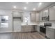 New kitchen featuring modern appliances, stylish cabinetry, and durable quartz countertops at 1005 Sims Nw Ave, Atlanta, GA 30318