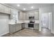 Bright kitchen featuring gray cabinets, quartz countertops, and stainless steel appliances at 1005 Sims Nw Ave, Atlanta, GA 30318