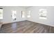 Bright, airy living space featuring new flooring, large windows, and a glass-panel door at 1005 Sims Nw Ave, Atlanta, GA 30318