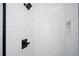 Tiled shower features sleek black fixtures and a built-in niche for storage at 1005 Sims Nw Ave, Atlanta, GA 30318