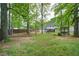 Spacious backyard with mature trees, a deck, and a pergola providing ample outdoor space at 1315 Bustling Sw Ln, Marietta, GA 30064