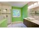 Bright bathroom featuring a modern vanity, vessel sink, and a shower with glass doors at 1315 Bustling Sw Ln, Marietta, GA 30064