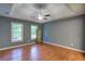 Well-lit bedroom with tray ceiling, wood flooring, and bright grey walls at 1315 Bustling Sw Ln, Marietta, GA 30064