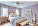 Tranquil bedroom featuring a ceiling fan, and abundant natural light from two windows at 1315 Bustling Sw Ln, Marietta, GA 30064