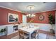 Elegant dining room featuring wainscoting, a modern chandelier, and ample space for entertaining guests at 1315 Bustling Sw Ln, Marietta, GA 30064