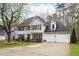 Charming two-story home with a well-manicured lawn, two-car garage, and classic architectural details at 1315 Bustling Sw Ln, Marietta, GA 30064