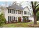 Traditional two-story home with a red front door, dark shutters, and mature landscaping at 1315 Bustling Sw Ln, Marietta, GA 30064