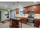 Modern kitchen with stainless steel appliances, center island, and ample cabinet space at 1315 Bustling Sw Ln, Marietta, GA 30064