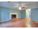 Bright living room features a traditional fireplace and hardwood floors, creating a warm and inviting atmosphere at 1315 Bustling Sw Ln, Marietta, GA 30064