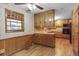Charming eat-in kitchen featuring wooden cabinets, hardwood floors, and vintage wallpaper at 1470 Biltmore Ne Dr, Atlanta, GA 30329