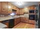 Well-lit kitchen with wooden cabinets, stainless steel appliances, and hardwood floors at 1470 Biltmore Ne Dr, Atlanta, GA 30329