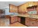 A full view of a spacious kitchen with wooden cabinetry and hardwood flooring at 1470 Biltmore Ne Dr, Atlanta, GA 30329
