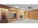 Spacious living room with a stone fireplace, wood paneling, and built-in features at 1470 Biltmore Ne Dr, Atlanta, GA 30329
