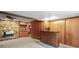 Large recreation room featuring a stone fireplace, wood paneling, and a wet bar at 1470 Biltmore Ne Dr, Atlanta, GA 30329
