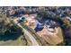 Aerial view of a residential community under construction, featuring tree-lined streets and various stages of development at 2875 Caney Parc Way, Cumming, GA 30041
