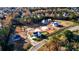 Aerial view of a planned community with homes in various stages of construction, surrounded by trees at 2875 Caney Parc Way, Cumming, GA 30041