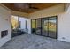 Covered patio with a stone floor, outdoor fireplace, and sliding glass doors at 2875 Caney Parc Way, Cumming, GA 30041