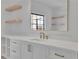 Well-lit bathroom featuring a modern vanity with sleek fixtures and floating shelves at 2875 Caney Parc Way, Cumming, GA 30041