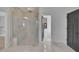 Modern bathroom featuring a glass-enclosed shower and neutral tile flooring at 2875 Caney Parc Way, Cumming, GA 30041
